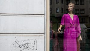 a mannequin wearing a pink dress and a pink jacket